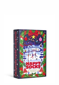 Caja de set de regalos de calendario de Adviento con una vibrante escena invernal, acentos rojos y verdes, texto "HAPPY SOCKS" e ilustraciones festivas.