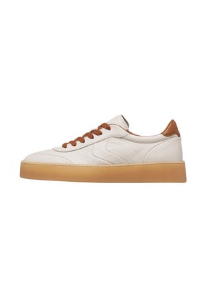 Sneaker in pelle bianca low-top con lacci marroni, linguetta marrone sul tallone e suola spessa in gomma marrone chiaro vista di profilo.