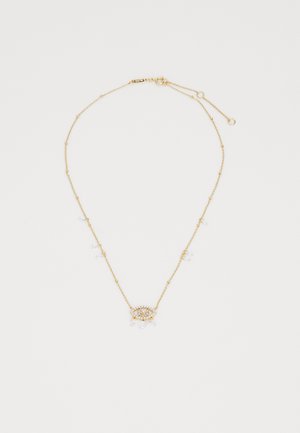 Gold necklace with delicate chains, featuring a central eye-shaped design adorned with clear beads and small dangling accents.
