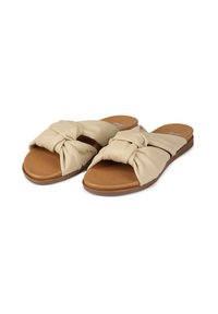 Beige slide sandals with knotted fabric straps, a smooth tan footbed, and a flexible rubber sole for comfort and ease of wear.