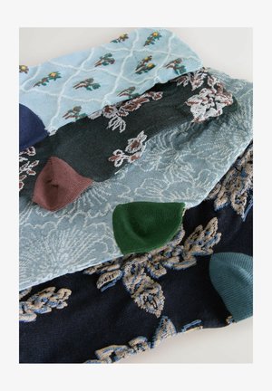 Textile fabric swatches in various colors: light blue, dark green, navy, and burgundy, featuring floral and geometric embroidery patterns.