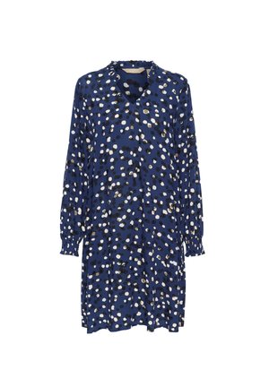 Vestido de marina con un patrón de lunares dispersos en negro, blanco y verde. Mangas largas con puños elásticos, escote en V y adornos con volantes.