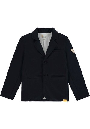 Blazer noir pour enfants avec revers crantés, deux poches avant, deux boutons et une petite écusson sur la manche gauche.