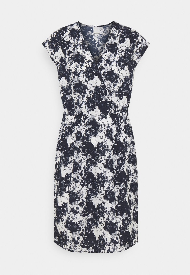 Robe portefeuille sans manches avec imprimé floral abstrait noir et blanc, encolure en V et taille élastique, présentée sur un fond clair uni.