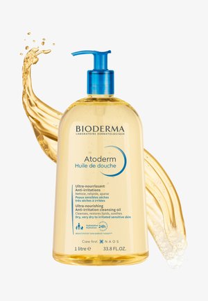 Bioderma Atoderm shower oil in a clear plastic bottle with a blue pump. Contains a light yellow liquid with text on the label in multiple languages.