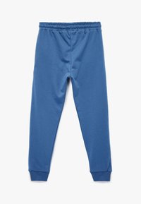 Blå bomuldsblandede joggers med elastisk talje, tapered ben og ribstrikkede cuffs, der har en glat og blød tekstur.
