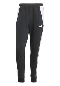 Schwarze Jogginghosen mit weißen Seitenstreifen, elastischem Bund und gerippten Knöchelbündchen. Mit einem Adidas-Logo auf dem linken Oberschenkel. Material aus Baumwollmischung.