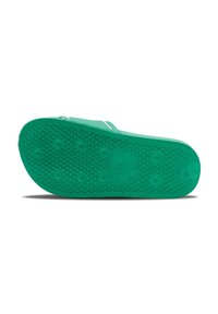 Green rubber sandal outsole with textured surface and circular grip patterns. Includes drainage holes and a central logo.