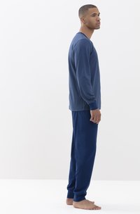 Marineblauwe pyjama set met lange mouwen en broek, met een horizontaal gestreept patroon op de top en een effen kleur op de onderkant. Zachte stof.
