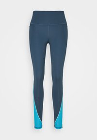 Mörkblå leggings med hög midja, ljusblå kurviga paneler på vaderna och en liten logotyp på nedre vänstra benet.