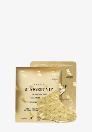 Emballage doré du masque pour les pieds STARSKIN VIP, avec un masque en feuille décoré d’étoiles, présenté comme un soin adoucissant à effet sauna.