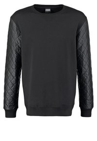 Maglione a girocollo nero con maniche in pelle trapuntata e polsini e orlo a costine.