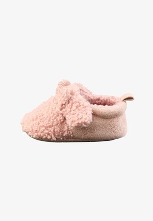 Soft pink baby slipper with curly fabric and a small loop at the heel, designed for comfort and warmth.