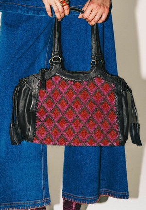 Black leather handbag with red and pink diamond pattern, featuring a textured surface, dual top handles, and tassel accents.