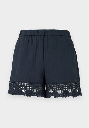 Shorts femme bleu marine avec taille élastique et bordure en dentelle florale le long de l'ourlet sur un fond clair uni.