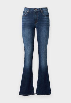 Jean flare bleu en denim. Caractéristiques d'une taille haute, de cinq poches et d'une légère décoloration près de l'ourlet. Coutures de couleur contrastante.