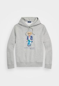 Šedá mikina z měkké bavlny, která má na sobě grafiku medvěda v modrém saku se slunečními brýlemi a pruhovanou košilí. Součástí je kapuce se šňůrkou.