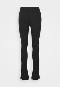 Zwarte, geribbelde leggings met een flared onderkant en glinsterende accenten door het gehele ontwerp, gemaakt van rekbaar materiaal voor een aansluitende pasvorm.