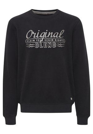 Črna dukserica s krožno ovratnikom. Ima poudarjen bel vezen napis: "Izvirni UZEMLITE SVOJA DENIM PRAVICE MEŠANJE."