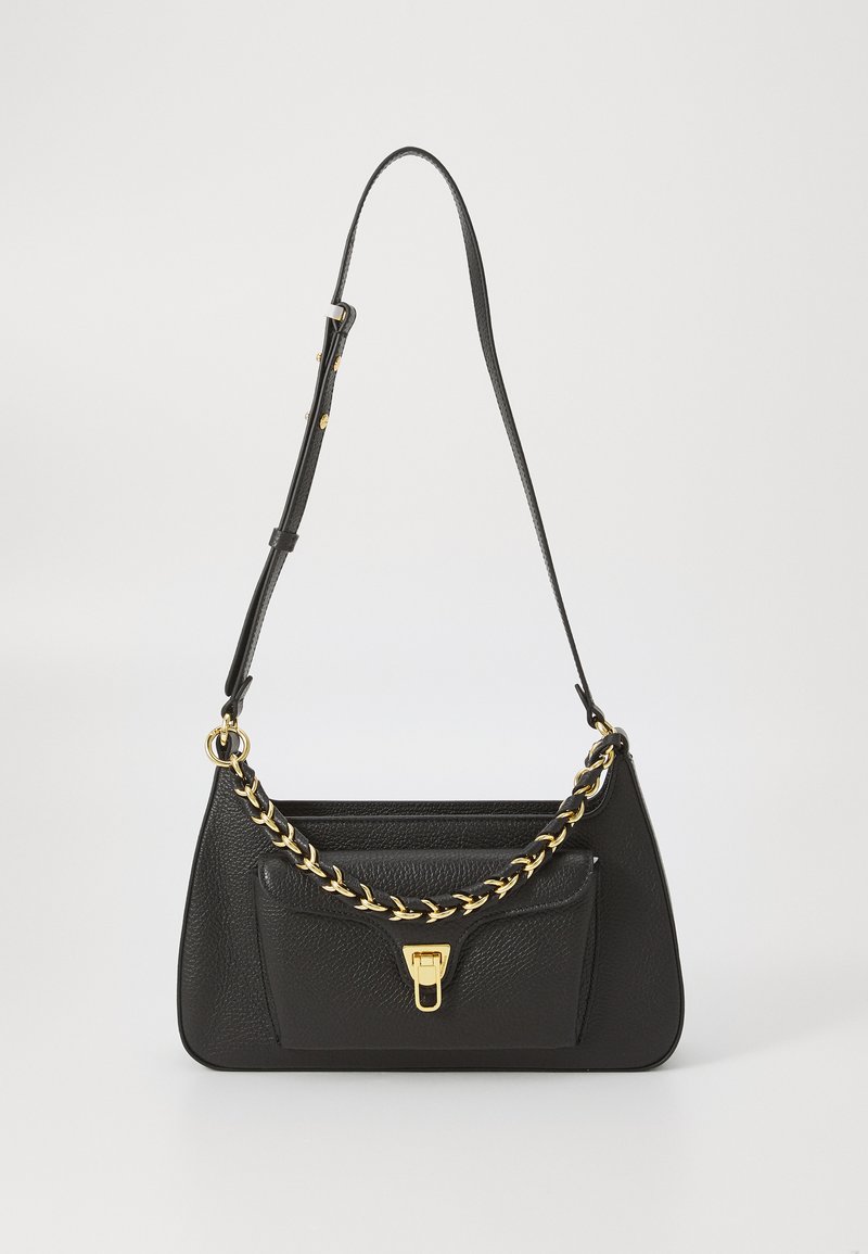 Black leather handbag with a structured shape, gold chain accent, and a front pocket. Features an adjustable strap for versatile carrying.