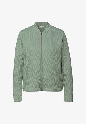 Světlounce zelená bomber bunda s rybí kostrou vzorem, zapínáním na zip a bočními kapsami. Má žebrované manžety a lem pro přiléhavý vzhled.