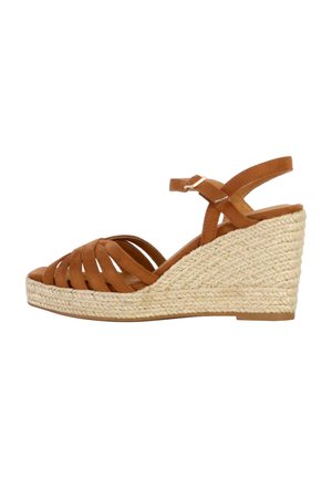 Sandaletta con tacco a cuneo in suede marrone, con suola in juta intrecciata, cinturino alla caviglia regolabile e design incrociato. La parte superiore presenta un design open-toe.