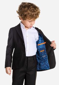 Black suit jacket with two buttons and side pockets, lined with blue fabric featuring geometric patterns. Paired with a white dress shirt.