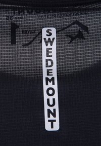 Black sports fabric with a grid pattern, featuring a white label reading "SWEDEMOUNT." Texture is smooth with a slight sheen.