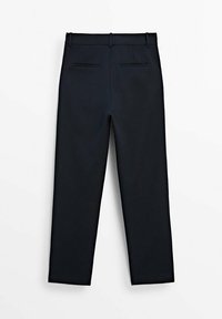 Mustat mittatilaustyönä tehdyt housut, joissa on vyölenkit ja kaksi takataskua, esiteltyinä litteänä valkoista taustaa vasten.