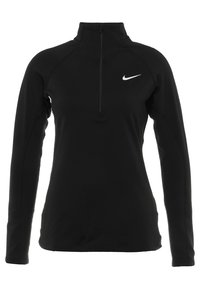 Musta pitkähihainen urheilupaita, jossa on neljännesvetoketju, valmistettu sileästä kankaasta. Paidassa on valkoinen Nike-logo vasemmalla rinnassa ja teksturoitua kangasta hihoissa.