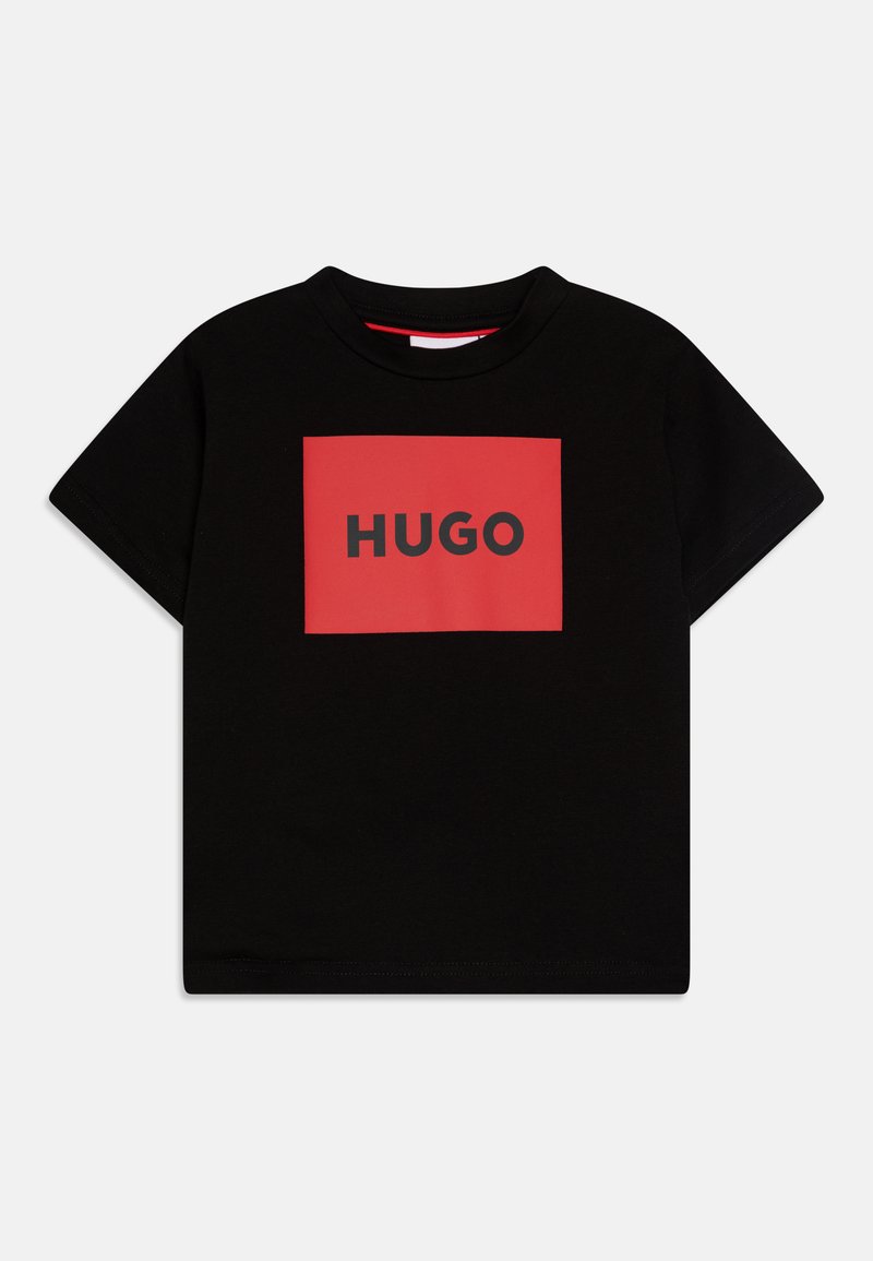 Black cotton t-shirt featuring a red rectangular logo with "HUGO" in bold black letters. Short sleeves and crew neckline.