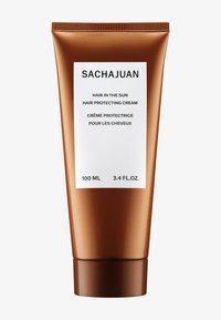 SACHAJUAN hårbeskyttende krem i en bronsefarget tube. Etiketten har svart tekst på hvit bakgrunn, med produktdetaljer på både engelsk og fransk.