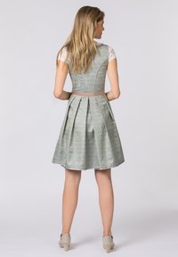 Light green floral dress with a fitted bodice, pleated skirt, and a satin belt. Features lace sleeves and a smooth, textured fabric.