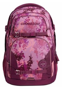 Backpack with a purple camouflage pattern, featuring various shades of pink and violet, fabric material, multiple zippered compartments, and adjustable straps.