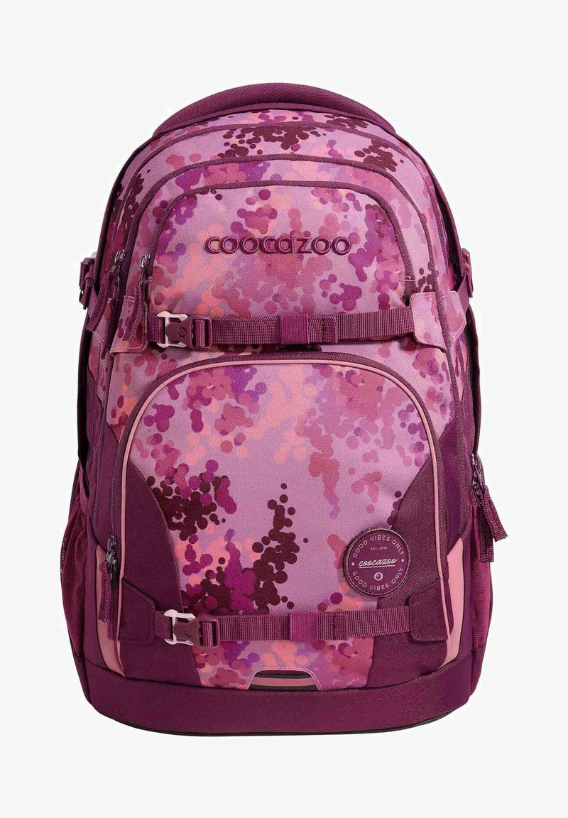 Backpack with a purple camouflage pattern, featuring various shades of pink and violet, fabric material, multiple zippered compartments, and adjustable straps.