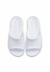 Bijele klizne sandale s teksturiranom unutrašnjošću i ventilacijskim rupama, s uzdignutim bijelim Nike logotipom preko trakice. Glatki plastični materijal.