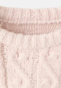 Halsauschnitt eines hellrosa gestrickten Pullovers mit geripptem Muster und erhabenen Strukturen. Weicher, flauschiger Stoff aus Wolle oder einem ähnlichen Material.