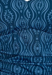 Tume sinine kangas, millel on sile tekstuur, peen heleroheline keerutatud mustriga ja kokkutõmmatud detailidega õmbluste kohal.