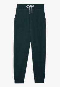 Tmavě zelené tepláky z měkkého materiálu, s páskem na šnurování v pase, bočními kapsami a žebrovými cuffs na kotnících.
