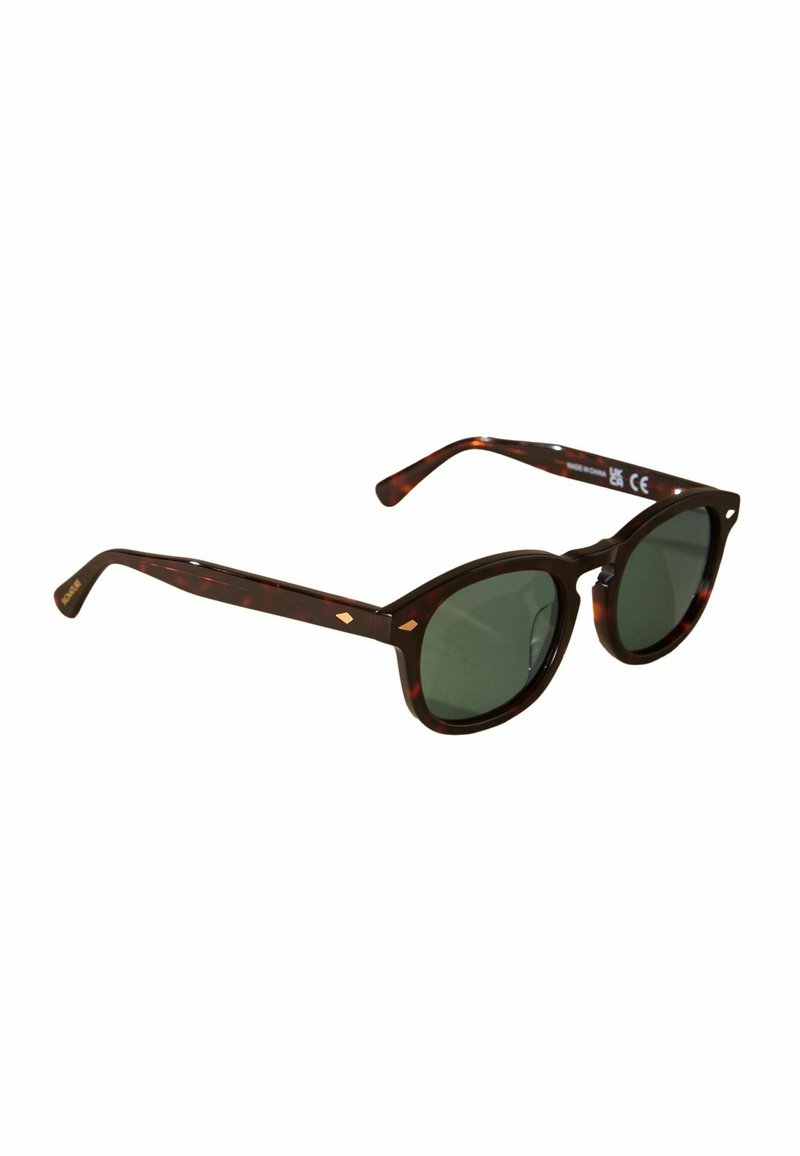 Tortoiseshell sunglasses with green lenses. Rounded shape, slim arms, and gold accent details on the frame. Durable plastic material.