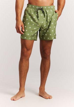 Groene zwemshorts met een palmboomprint, elastische tailleband en trekkoord. Lichtgewicht stof en een ontspannen pasvorm.