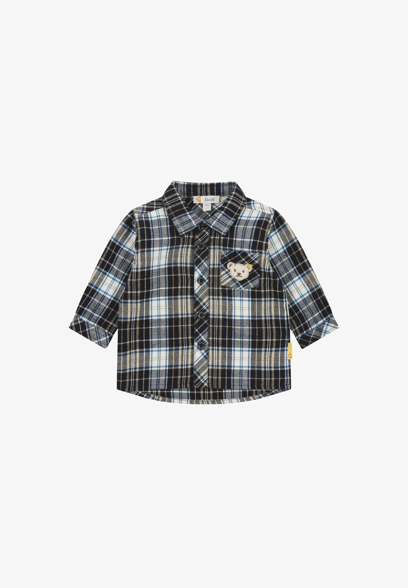 Chemise à manches longues en tartan bleu marine, crème et bleu clair. Dotée d'une poche poitrine avec un broderie d'ours et une fermeture par bouton. Matière en coton.