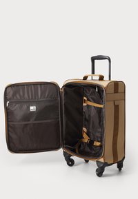 Brown rolling suitcase with a zippered opening, interior straps for securing items, and a mesh pocket on one side. Smooth-rolling wheels.