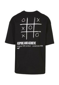 Black cotton t-shirt featuring a tic-tac-toe design in white and pink on the back, with text "ASPIRE AND ACHIEVE" below the graphic.
