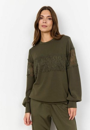 Olive green sweatshirt with long sleeves, featuring lace detailing across the chest and sleeves, made from soft, textured fabric.