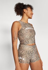 Set composto da un crop top e shorts in stampa leopardata, con design aderente, texture morbida e audace logo bianco sul tessuto.