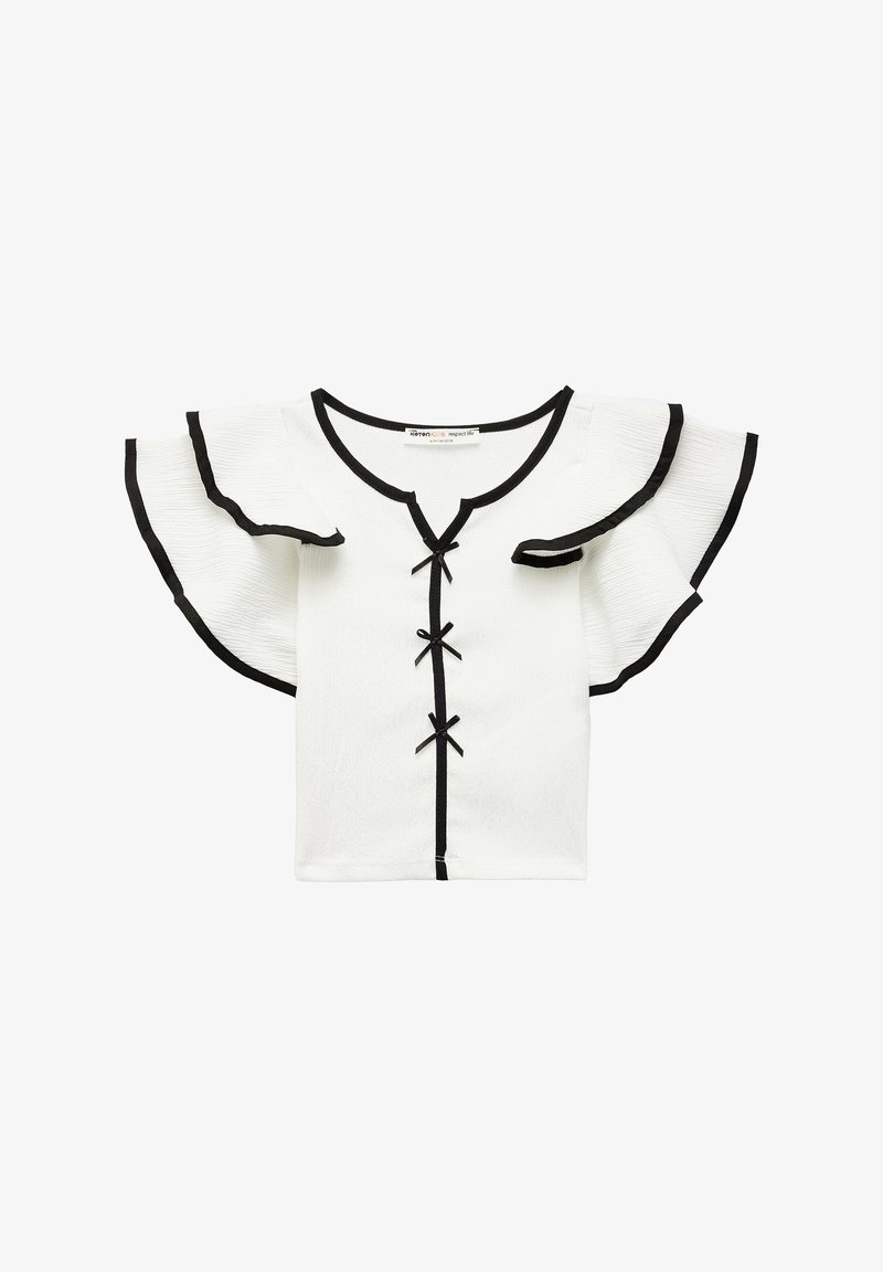 Biała bluzka krótki rękaw z czarnymi wykończeniami, dekoltem w kształcie litery V i falbaniastymi rękawami. Posiada dekoracyjne czarne kokardki biegnące wzdłuż środka. Teksturowany materiał.