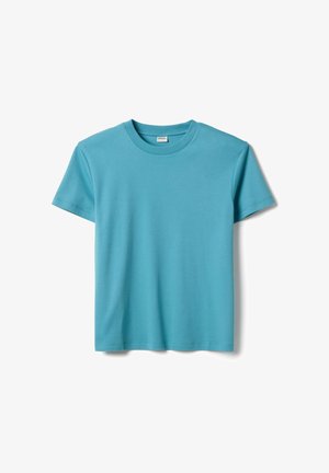 T-shirt uni turquoise à manches courtes et col rond, posé à plat sur un fond blanc.