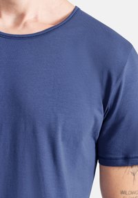 Navyblaue Kurzarm-T-Shirt aus weichem, glattem Material mit rundem Halsausschnitt und sichtbaren Nähdetails an den Ärmeln.