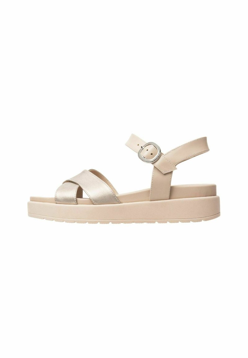 Beige platform sandals with a metallic cross strap design, adjustable ankle strap, and a textured sole for grip.